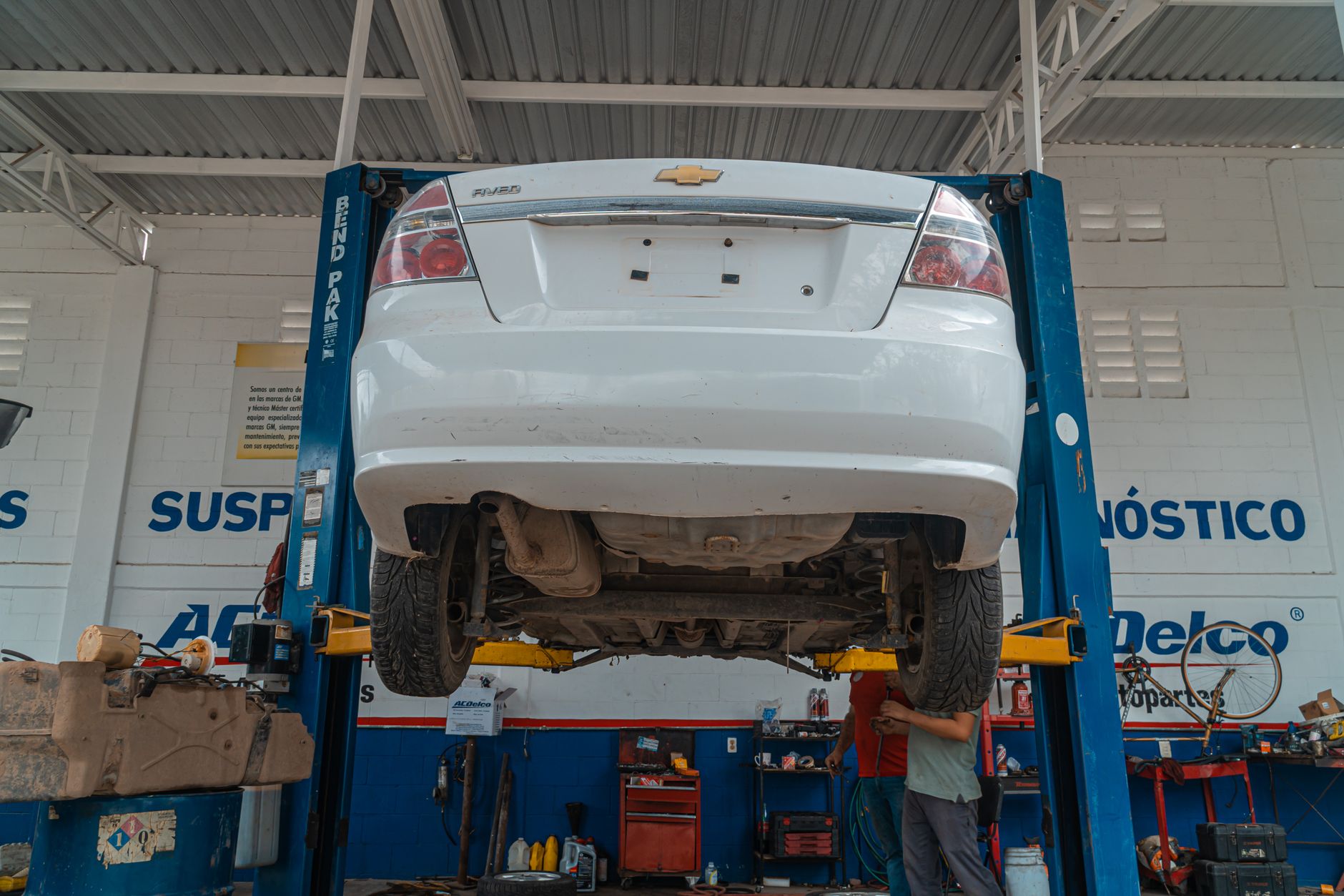 Vehicle lifted for maintenance in repair shop